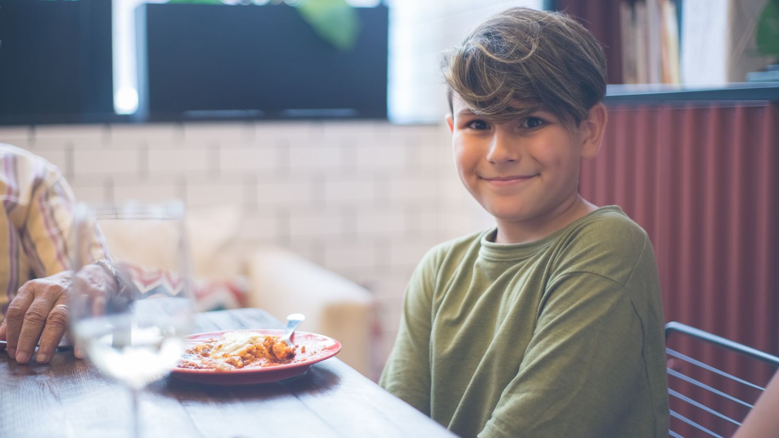 Smiling boy at a restaurant table