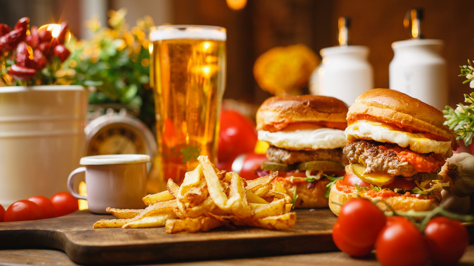 Burgers, fries and a beer on a restaurant table