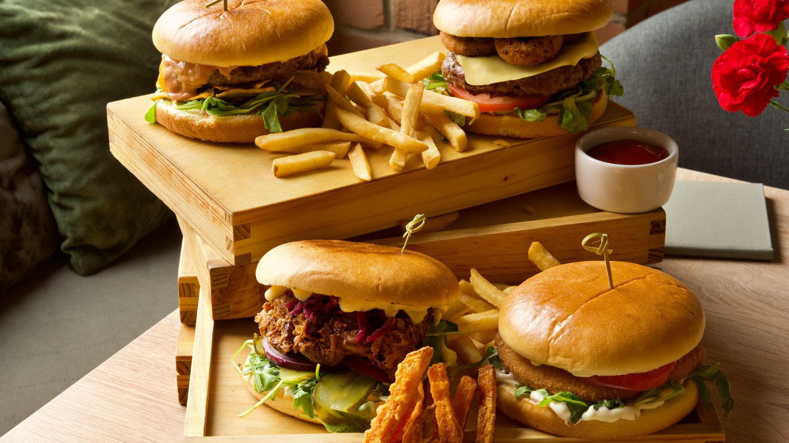 Burgers and fries served on wooden boards